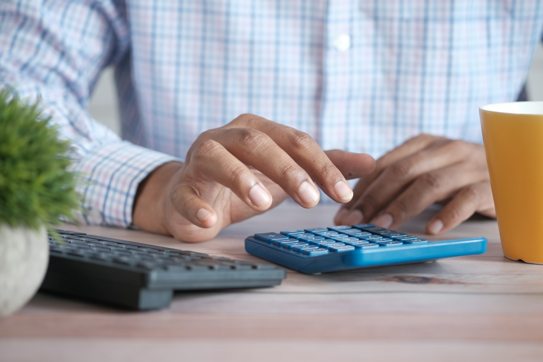 Accountant working through financial documents with a calculator