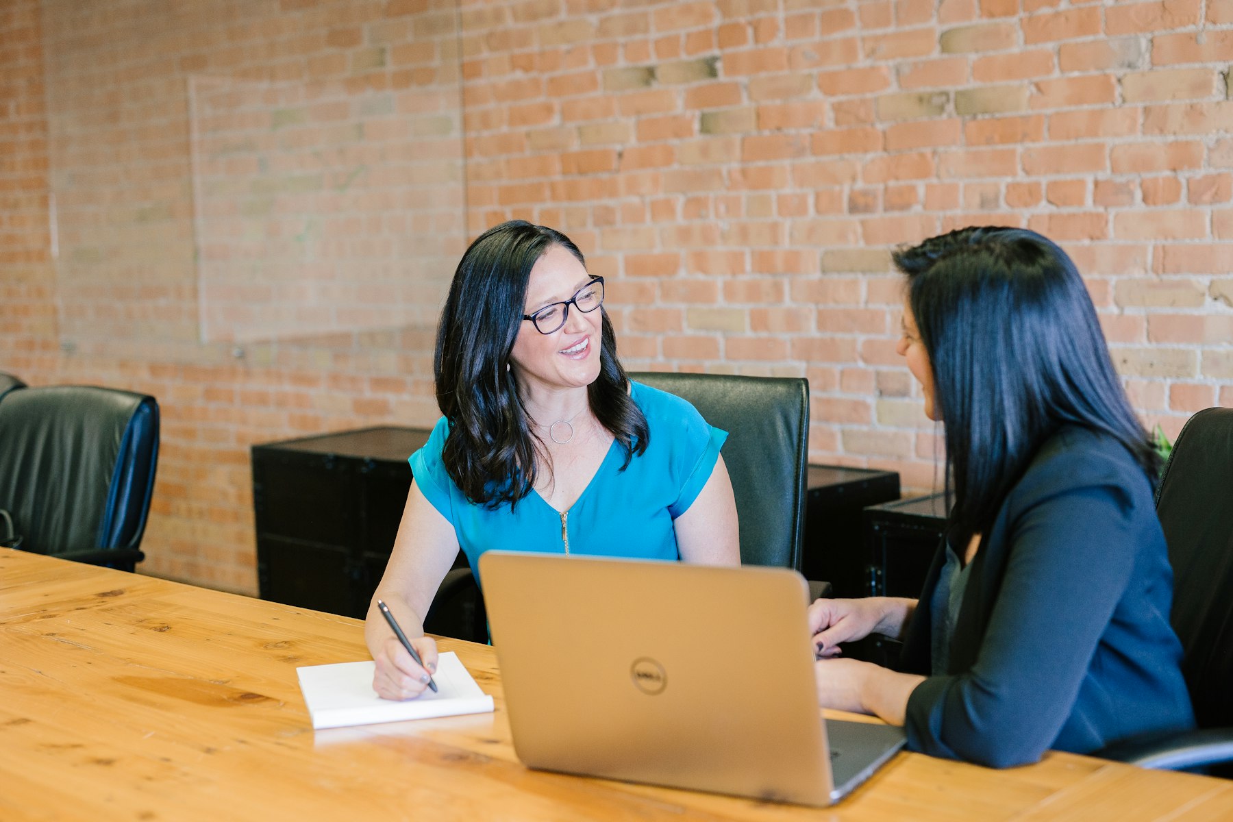 Financial advisors meeting with a client at a laptop